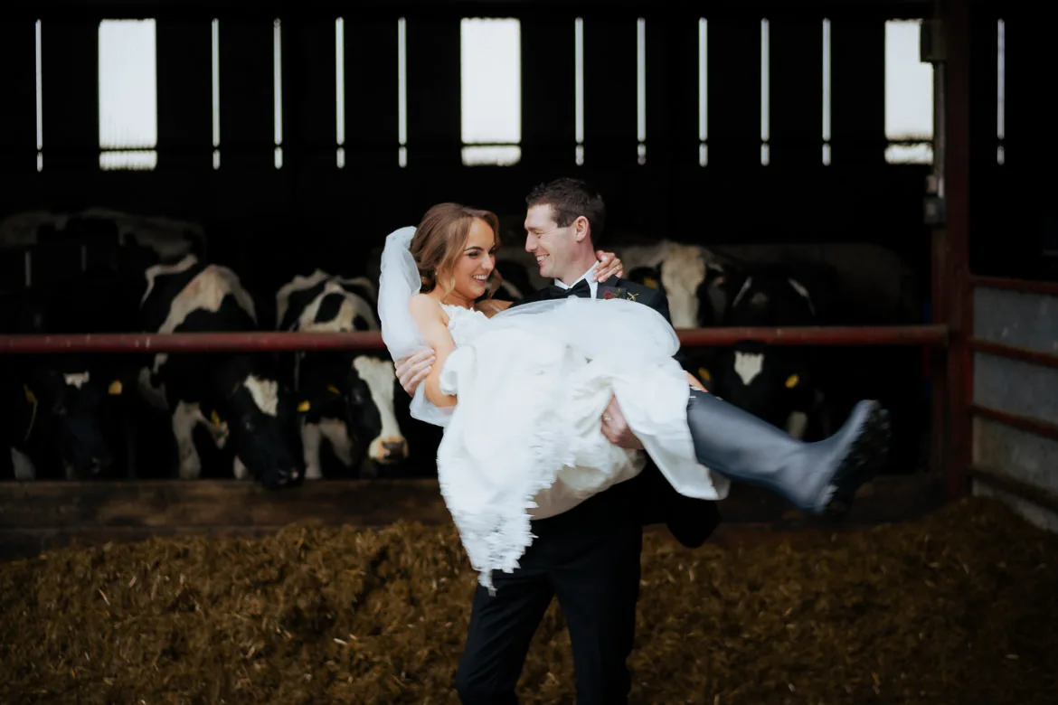 Bride groom wellies in cow shed