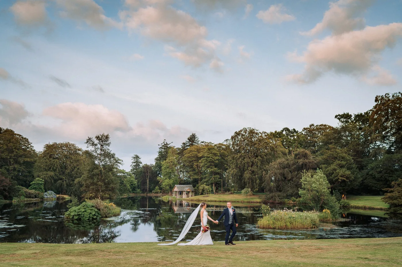 Bride and groom by the lake at the Carriage Rooms, Montalto Estate