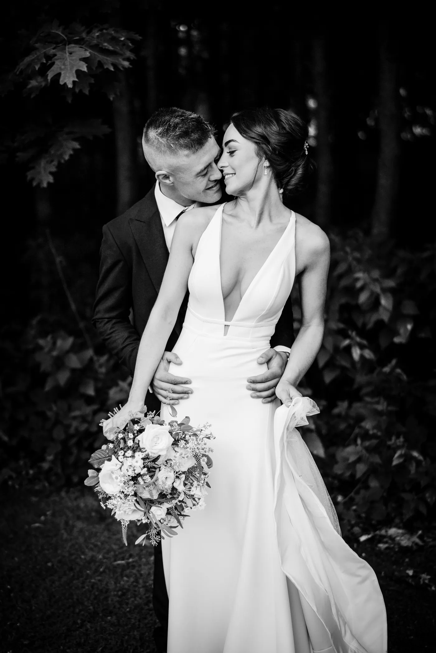 Groom holds wife